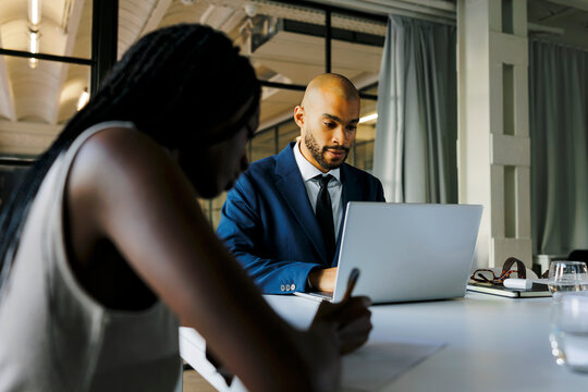 Business professionals working at a table in office setting