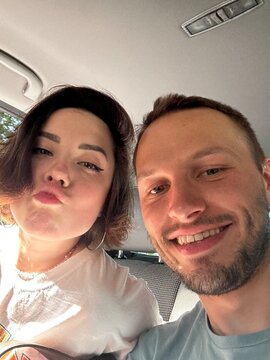 selfie of a young beautiful couple in a car