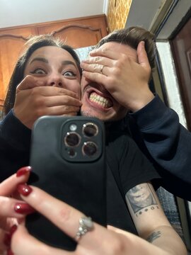 A funny selfie of a couple fooling around in the mirror. ugc
