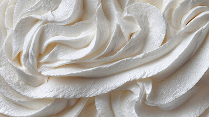 A close-up of beautifully swirled frosting, perfect for any dessert. The texture is smooth and creamy, with delicate swirls and peaks
