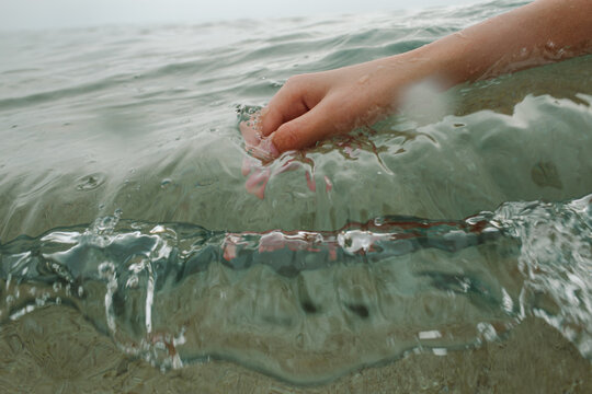 hand touching water