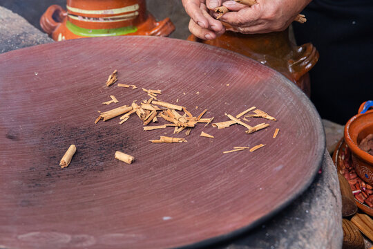 Traditional Rustic roasting cinnamon over a comal