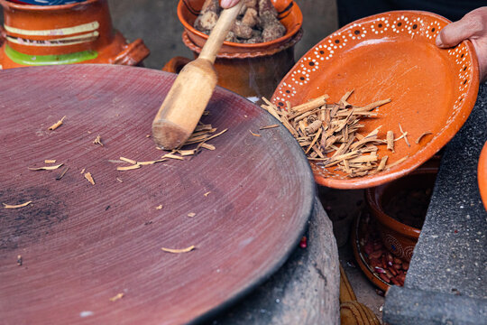 Traditional roasting of cinnamon in a Mexican comal