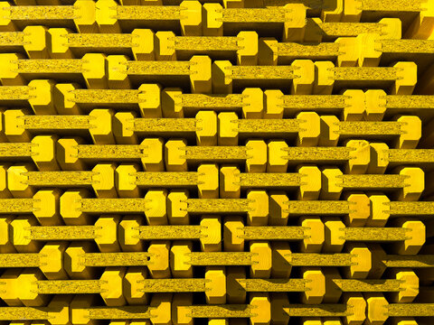 Close-up full-frame texture of stacked yellow wooden I-beams