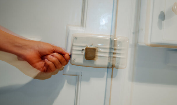 a hand unlocking a door, captured through shutter drag