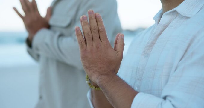 Meditation, prayer hands and fitness with people at beach for mindfulness, spiritual balance and health. Chakra, namaste pose and yoga routine with friends outdoor for holistic wellness and peace