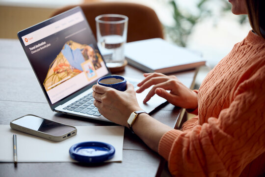 Anonymous woman uses laptop at her workplace