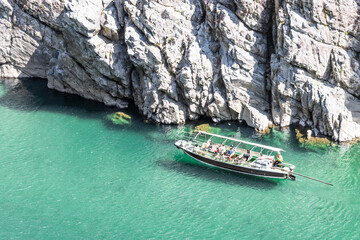 Sightseeing boat floating on clear turquoise water of river in valley of Oboke Gorge, Tokushima, Japan