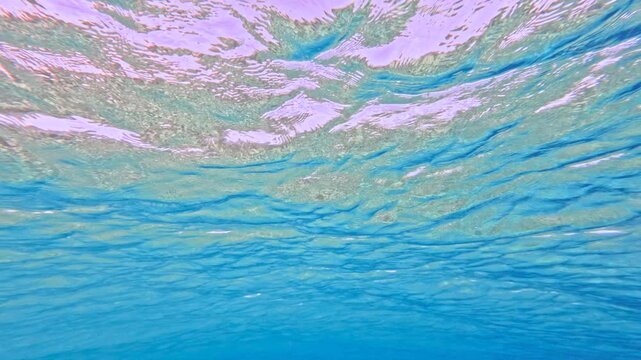 Abstract calm underwater water surface with blue light and waves