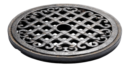 Ornate cast iron manhole cover isolated on transparent background, showing circular drain grate pattern