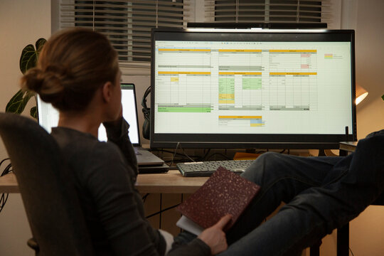 Woman analyzing financial data on computer at night
