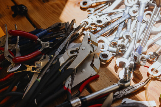 Tools Scattered on a Wooden Surface in a Workshop