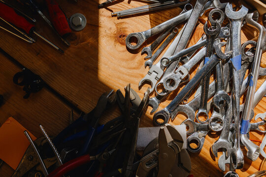 Tools Scattered on a Wooden Surface in a Workshop