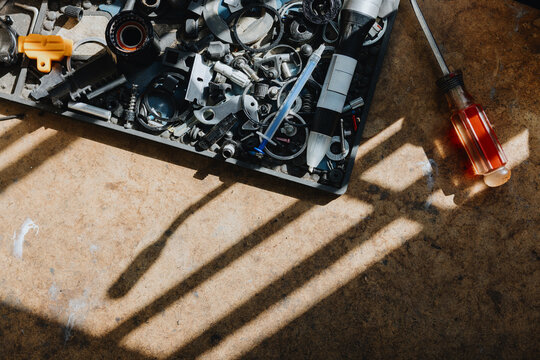 Tools and Spare Parts Scattered on a Workbench in a Workshop