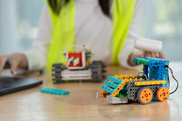 Colorful robotic vehicles built with STEM education kits placed on desk, symbolizing innovation, creativity and hands-on learning for kids in science and engineering projects.