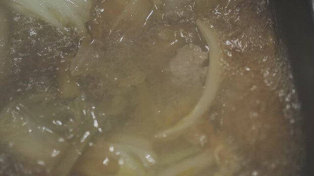 Boiling soup in a pot, highlighting food preparation safety and hygiene practices