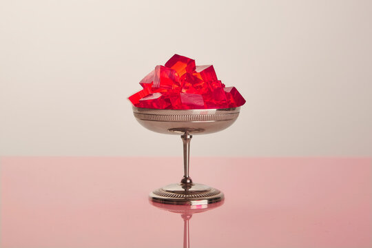 A silver goblet filled with strawberry gelatin