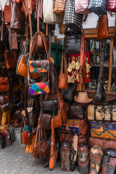 Leather bags hanging at Tangier market stall