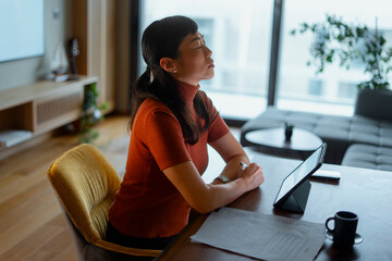 Woman meditating in home office finding calm during remote work
