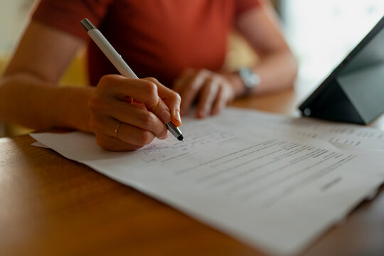 Woman signing business contract or legal document paperwork
