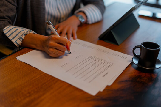 Woman signing business contract or agreement document
