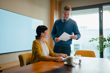 Business colleagues collaborating on paperwork during an office
