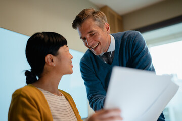 Business colleagues collaborating on documents during office meeting
