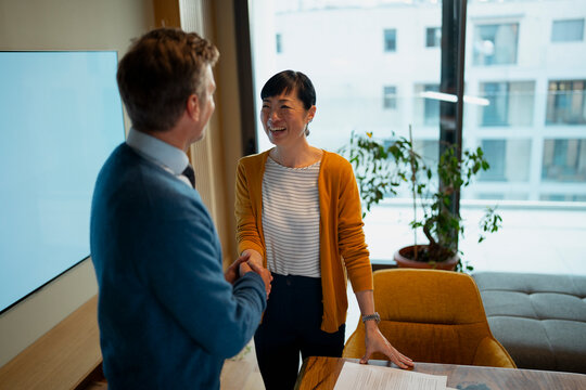 Business people shaking hands confirming partnership agreement

