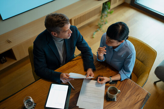 Business professionals discussing contract during an important meeting