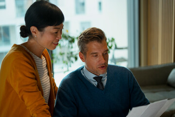 Diverse business professionals discussing documents and collaborating 