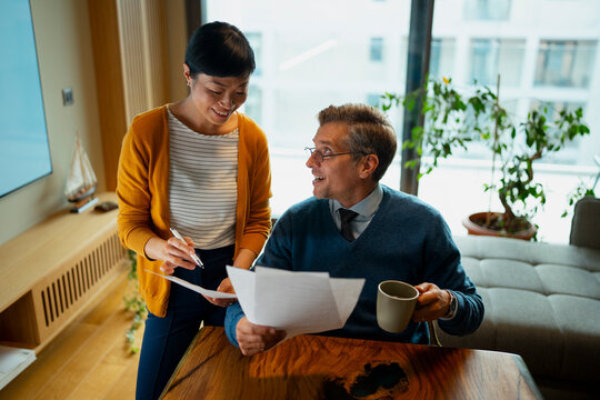 Couple discussing finances and planning investments at home
