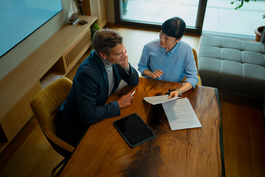 Financial consultant discussing business contract with client at home
