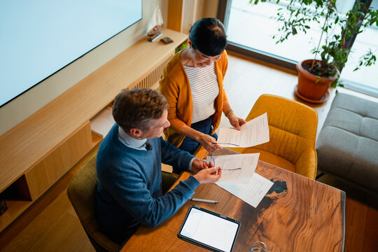 Financial advisor helping woman review investment plan documents
