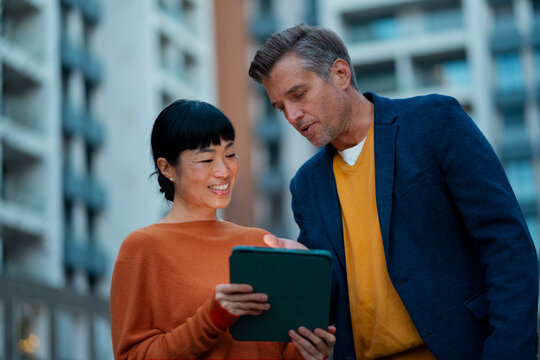Diverse business colleagues reviewing data on tablet
- Powered by Adobe
