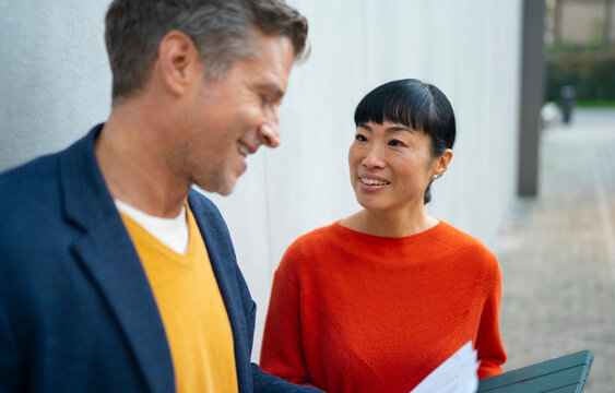 Coworkers discussing business during a productive outdoor meeting
