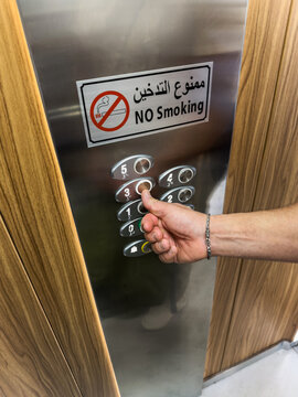 UGC photo of man pressing elevator button with no smoking sign