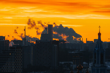 Sunset skyline with industrial smoke