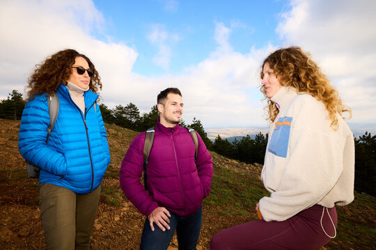 Friends converse in the mountains