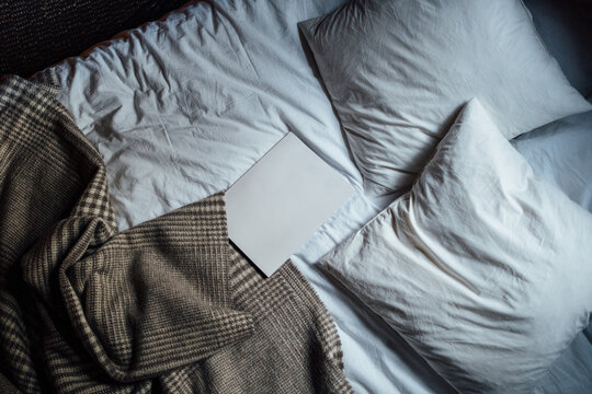 Cosy bed with a book on lying in the middle