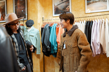 Retail worker assisting female customer in Tokyo clothing store