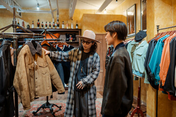 Japanese salesperson assisting female customer in a clothing store