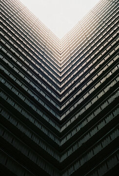 Symmetrical architecture looking up tall building
