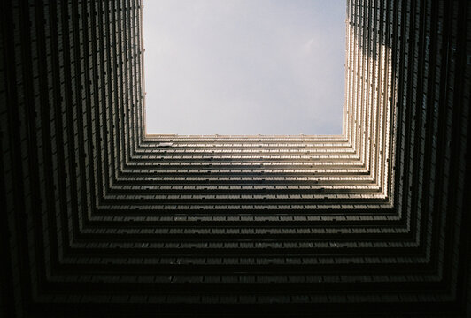 Symmetrical architecture looking up tall building
