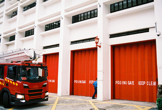 Red fire truck outside modern fire station
