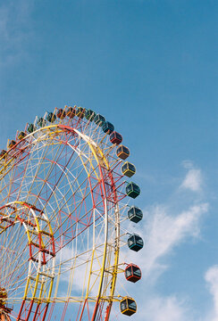 Colorful ferris wheel against blue summer sky
