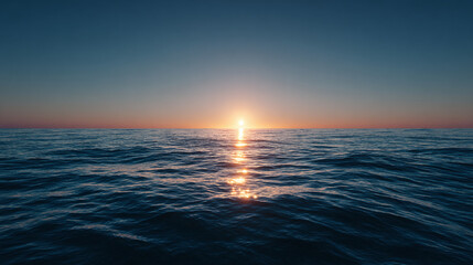 A stunning view of the sun setting over the ocean, reflecting off the water's surface, creating a beautiful and serene scene. The sky is clear, with a gradient of colors from blue to orange.