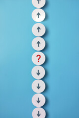 Up and Down Arrows with Question Mark on Paper Circles, Choice Concept