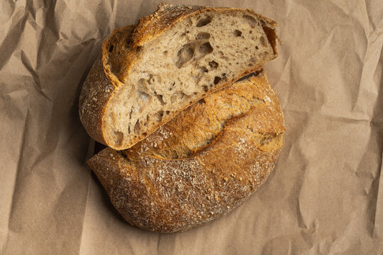 Crusty round artisan bread on brown paper