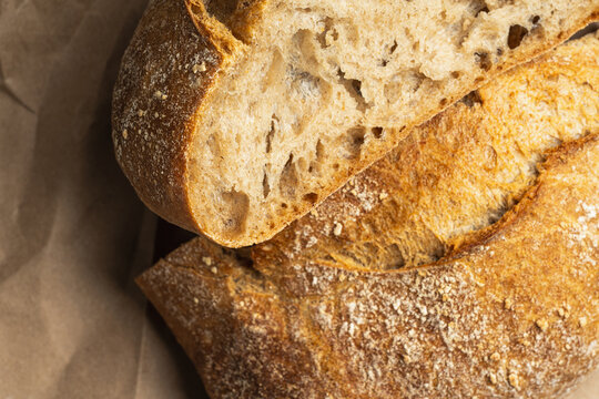 Crusty round artisan bread on brown paper
