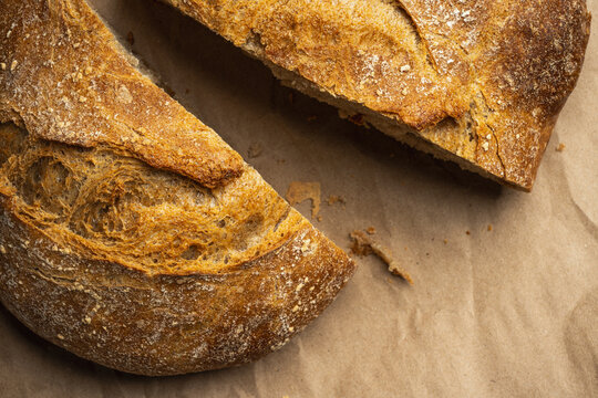 Sliced artisan bread loaf on brown paper